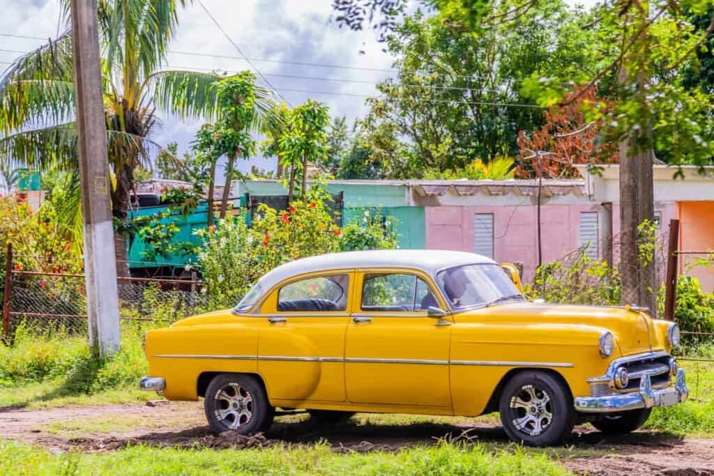 Old yellow american retro car parked in the countryside, Ciego De Avila, Cuba